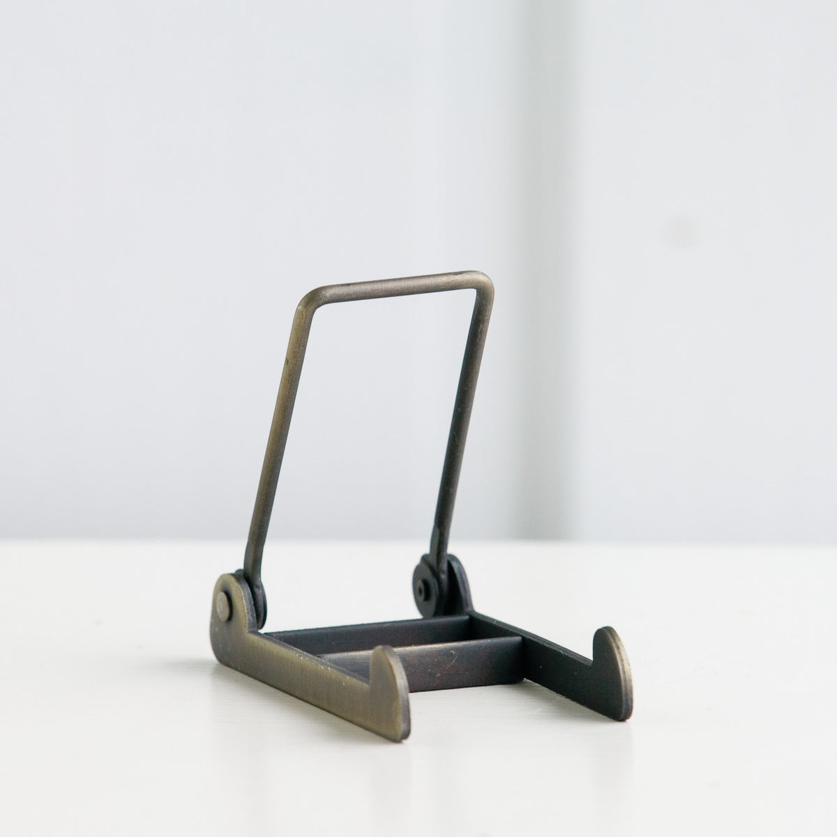 Silver wooden picture frame stand with two railings and one standing up