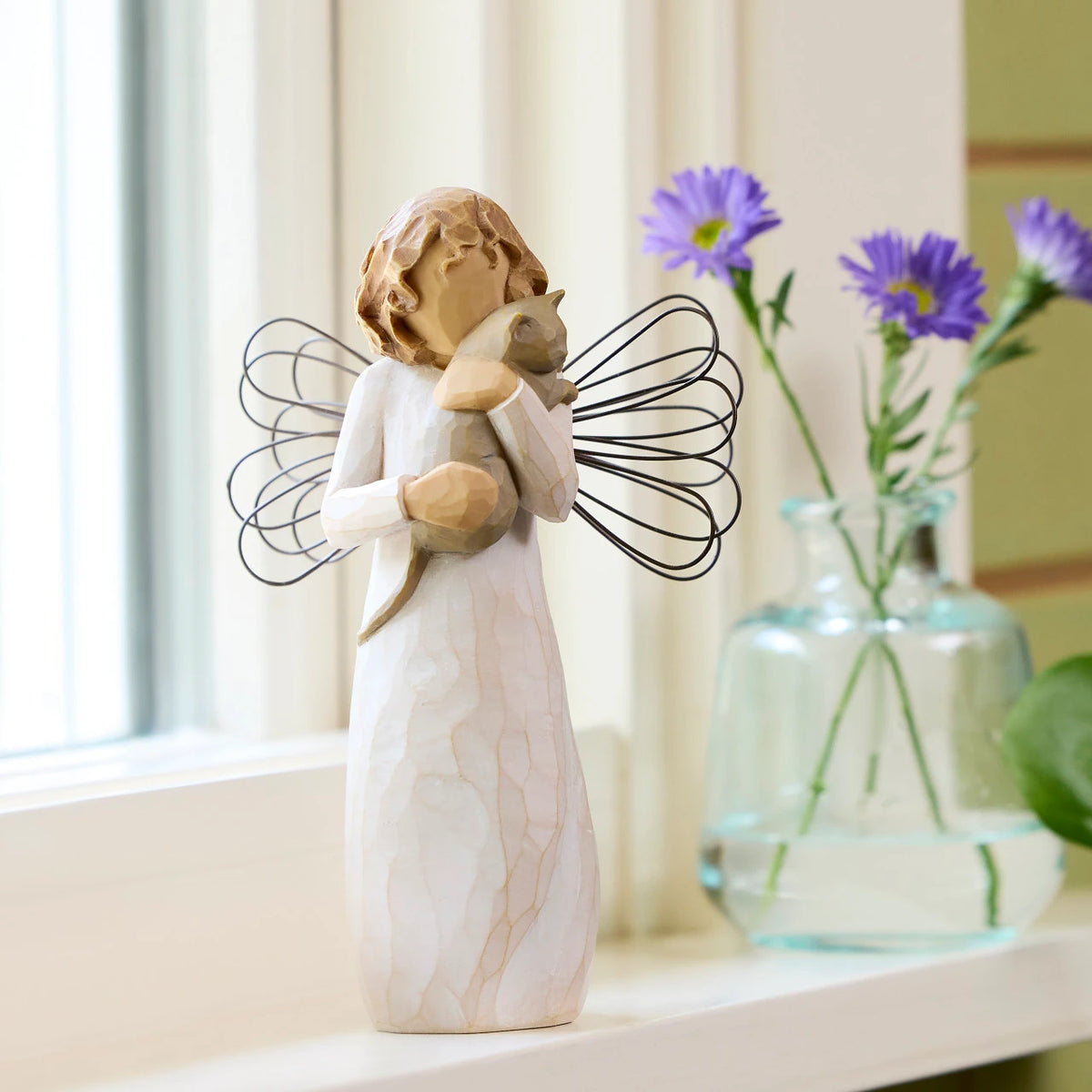 Willow Tree With affection, 5”h hand-painted standing resin angel figure, in cream dress with wire wings, holding gray cat, on sunny window ledge
