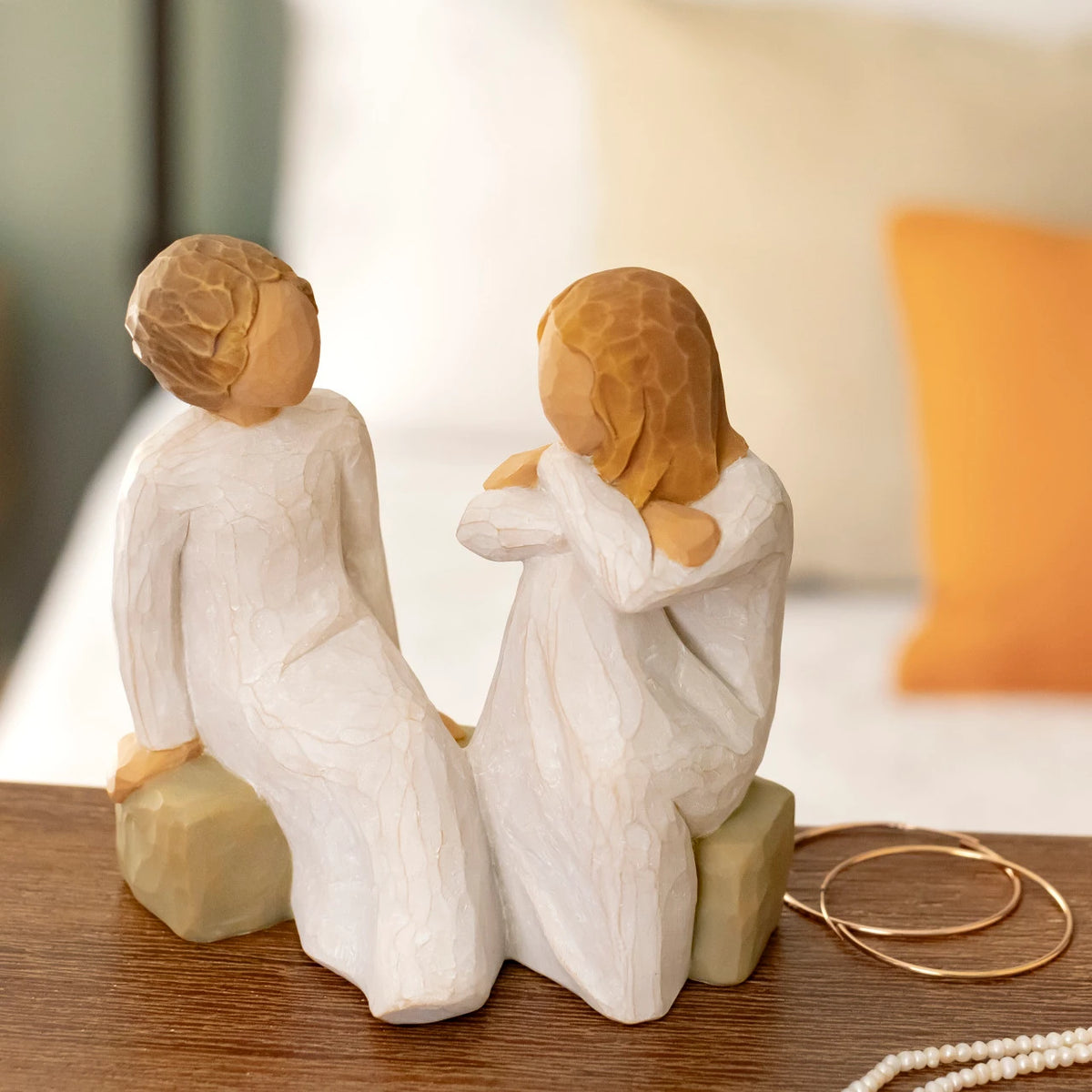 Willow Tree Heart and Soul, 4"h hand-painted resin figure of two women in cream dresses, facing, seated on gray bench, on wooden shelf