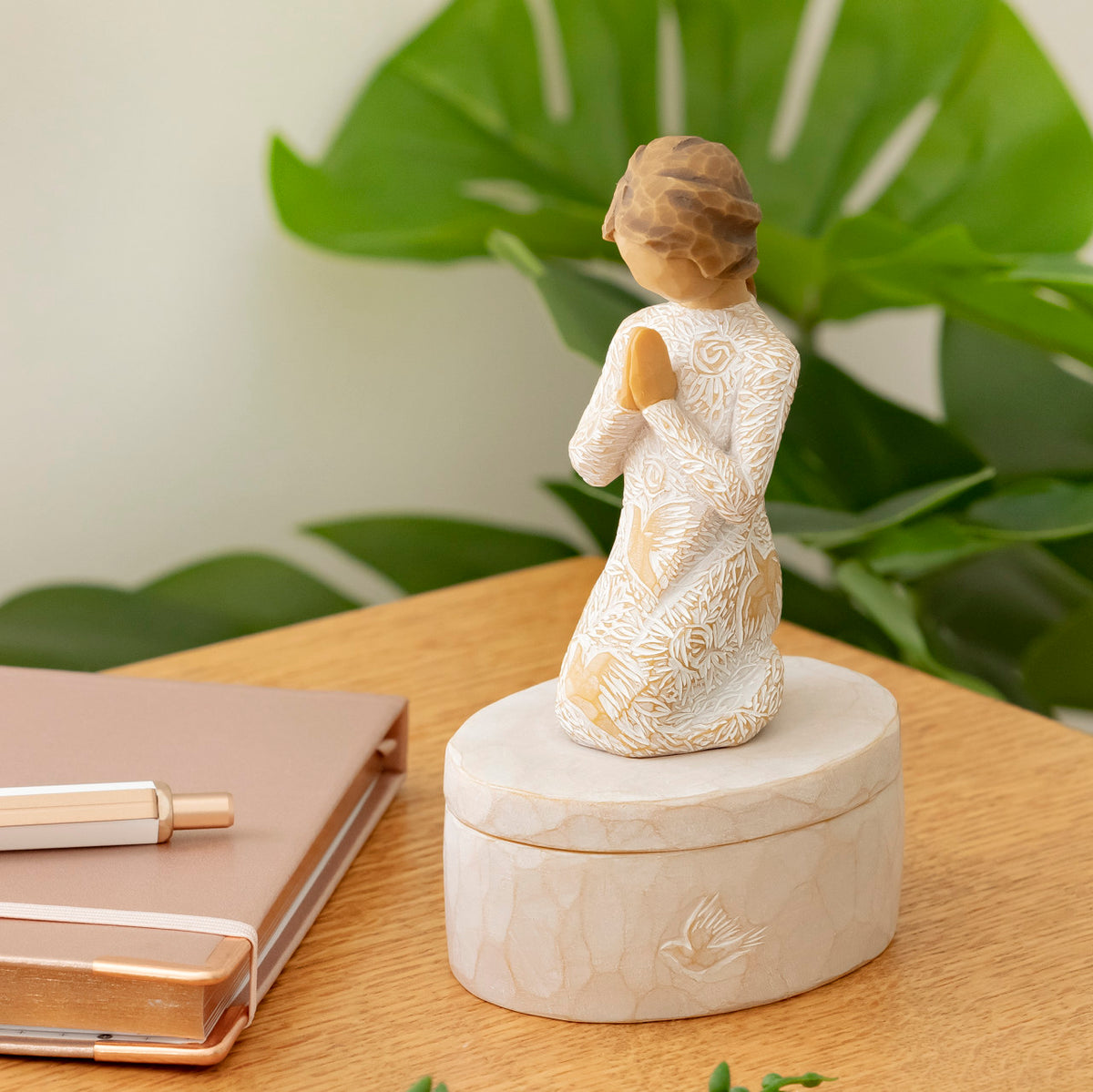 Willow Tree Prayer of Peace Keepsake Box, 3.5"oval hand-painted resin box with 3”H kneeling figure in cream dress carved with nature imagery, in prayer/meditation pose, affixed to lid, on desk