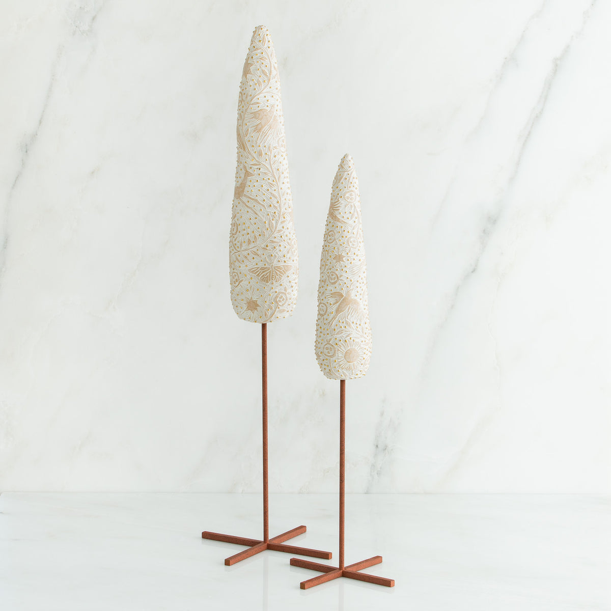 Set of two white tree figurines with wooden stands - all white background