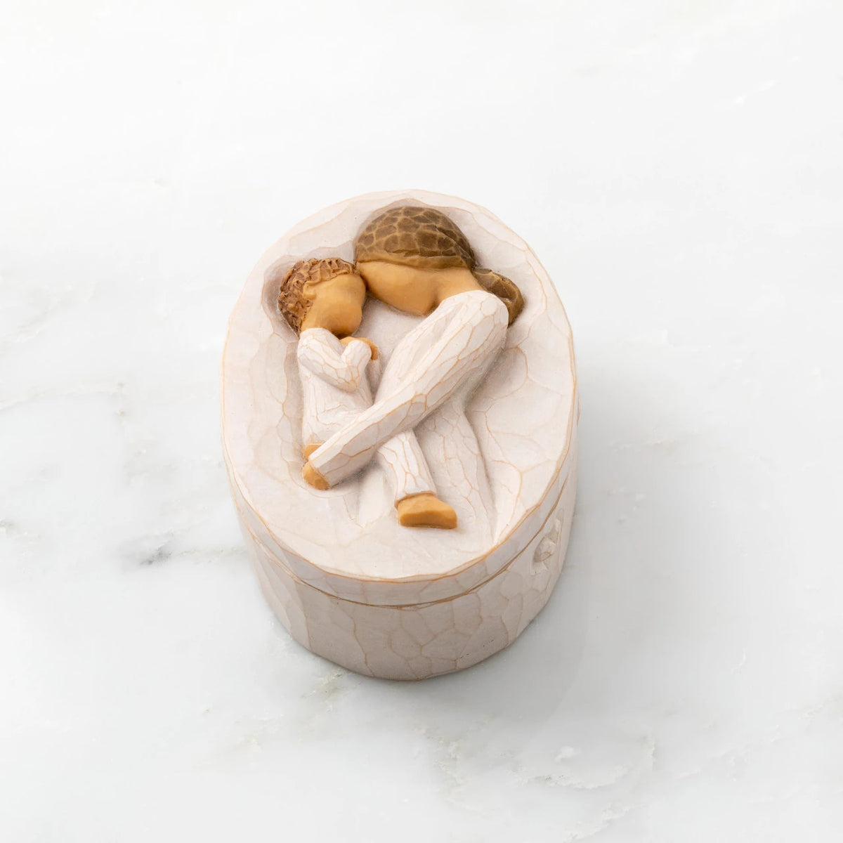 Willow Tree Tenderness Keepsake Box, 3.4" oval x 2.4" W x 1.5" D hand-painted resin box with removable lid. Lid has bas-relief carving of woman holding toddler, touching foreheads, inside of box has sentiment