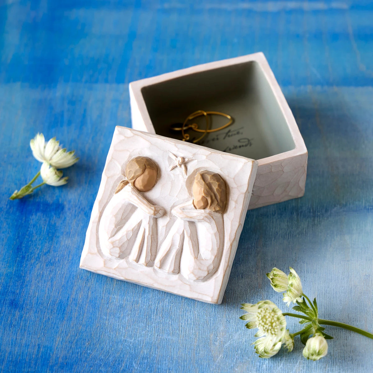 Willow Tree Friendship Keepsake Box, 3”sq x 2”h hand-painted resin box with removable lid off to one side. Lid has bas-relief carving of two seated figures in cream dresses, facing each other, inside of box has sentiment