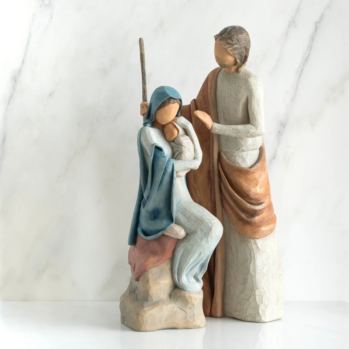 Nativity scene figurines - mother in blue holding child with father standing over them