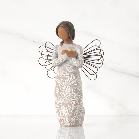Front view: angel with wire wings, darker skin, arms crossed over gold heart, dress carved with symbols of remembrance