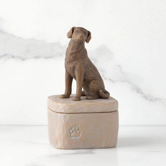 Front: gray square resin box with lid, 3-D figure of dark color dog atop lid