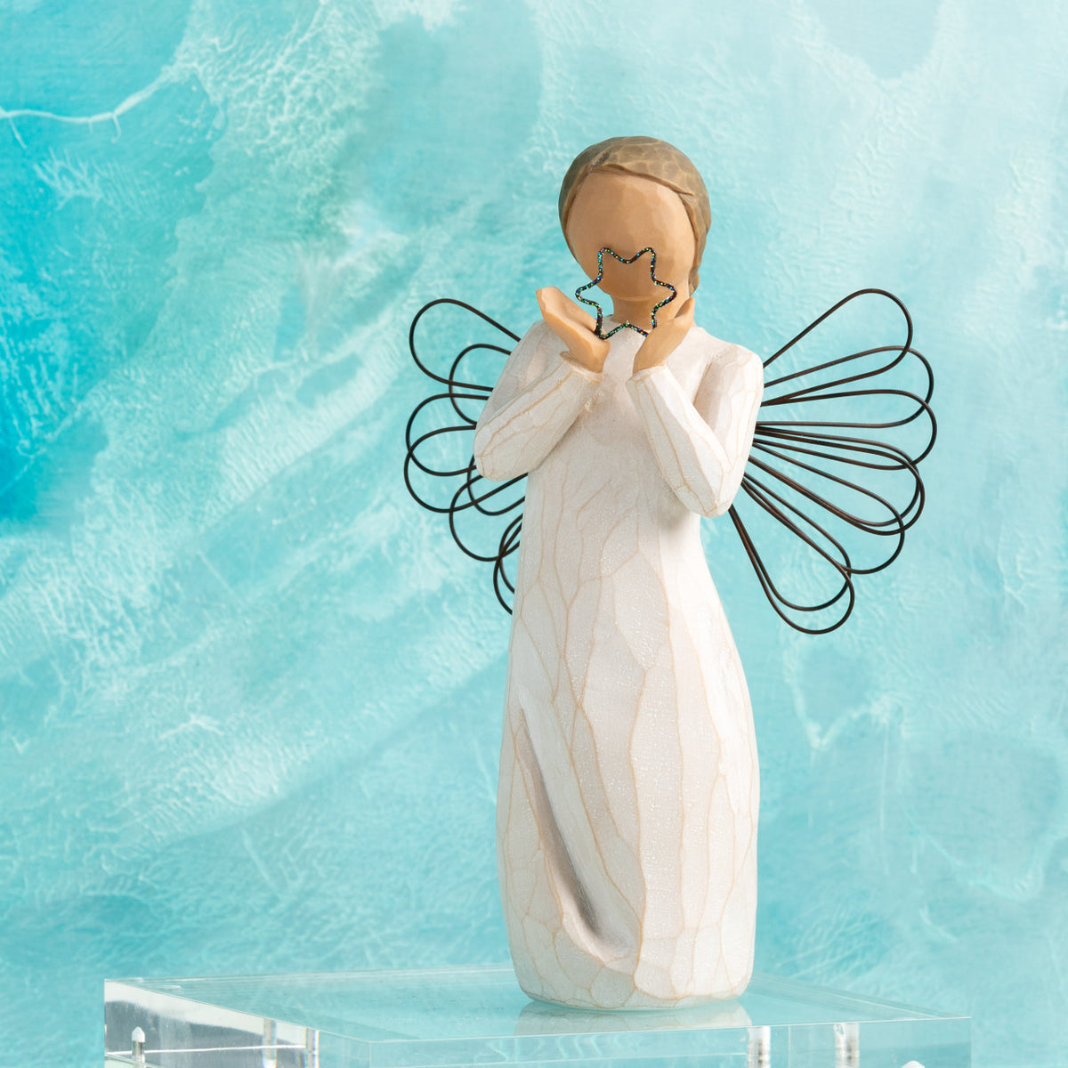 Willow Tree Bright Star, 6”h hand-painted standing resin angel figure in cream dress with wire wings, holding glittered wire star, in front of aqua painting
