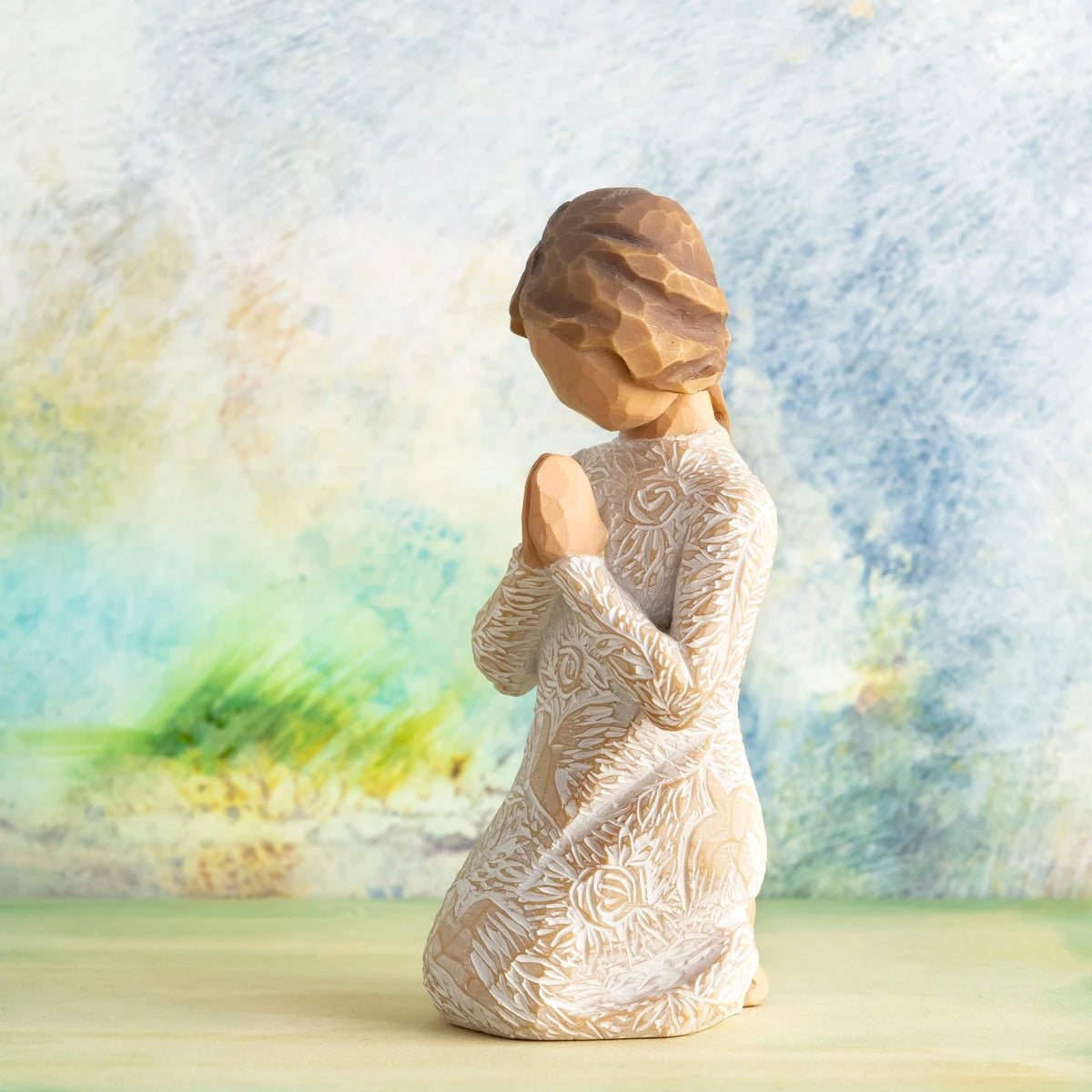 Willow Tree Prayer of Peace, 4”h hand-painted kneeling figure in cream dress heavily carved with birds and flowers, hands in prayer pose, in front of dusty blue/green painting