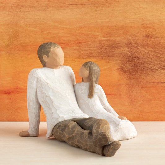 Willow Tree Father and Daughter, 5”h hand-painted resin figure of seated man dressed in neutral colors, legs outstretched, daughter in cream dress by his side, in front of sienna painting