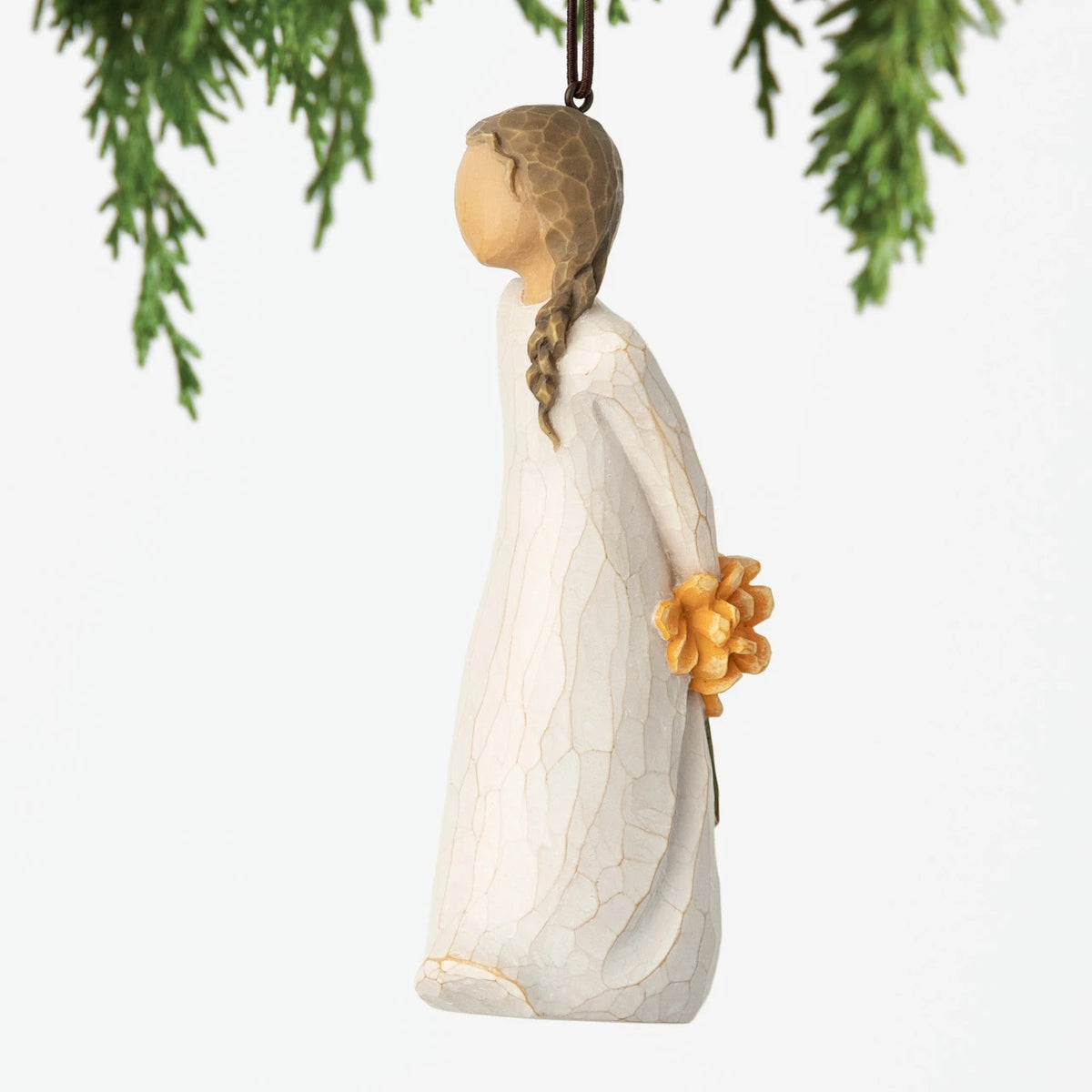 Left view, female figure with braid in cream dress, holding bouquet of orange flowers behind back. Hook and loop affixed to head