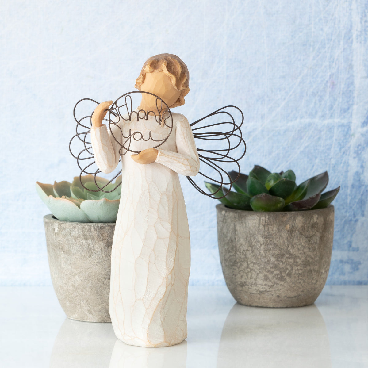 Willow Tree Just for You, 5.5”h hand-painted standing resin angel figure in cream dress with wire wings, holding wire circle with 'thank you' written in wire, on table with succulents