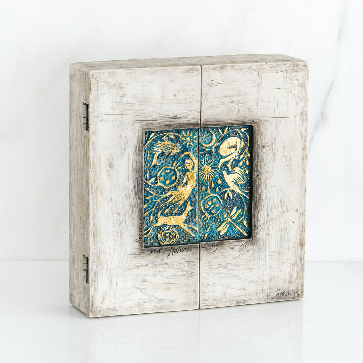 Light grey box with blue and gold scene square in the center