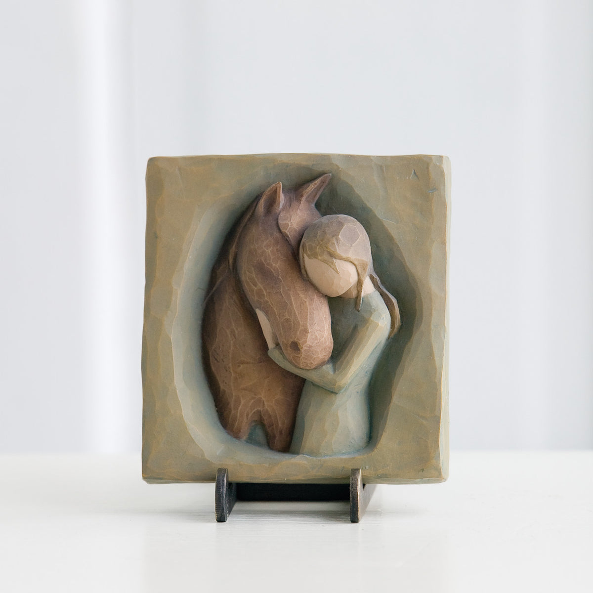 Small tan rectangle plaque with carved in horse and girl figurines