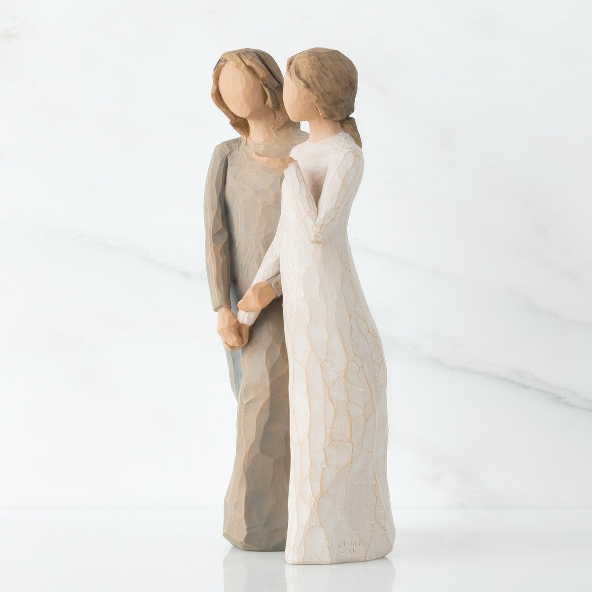 Set of two woman figurine standing up facing the side - one is in white dress, one is in brown dress