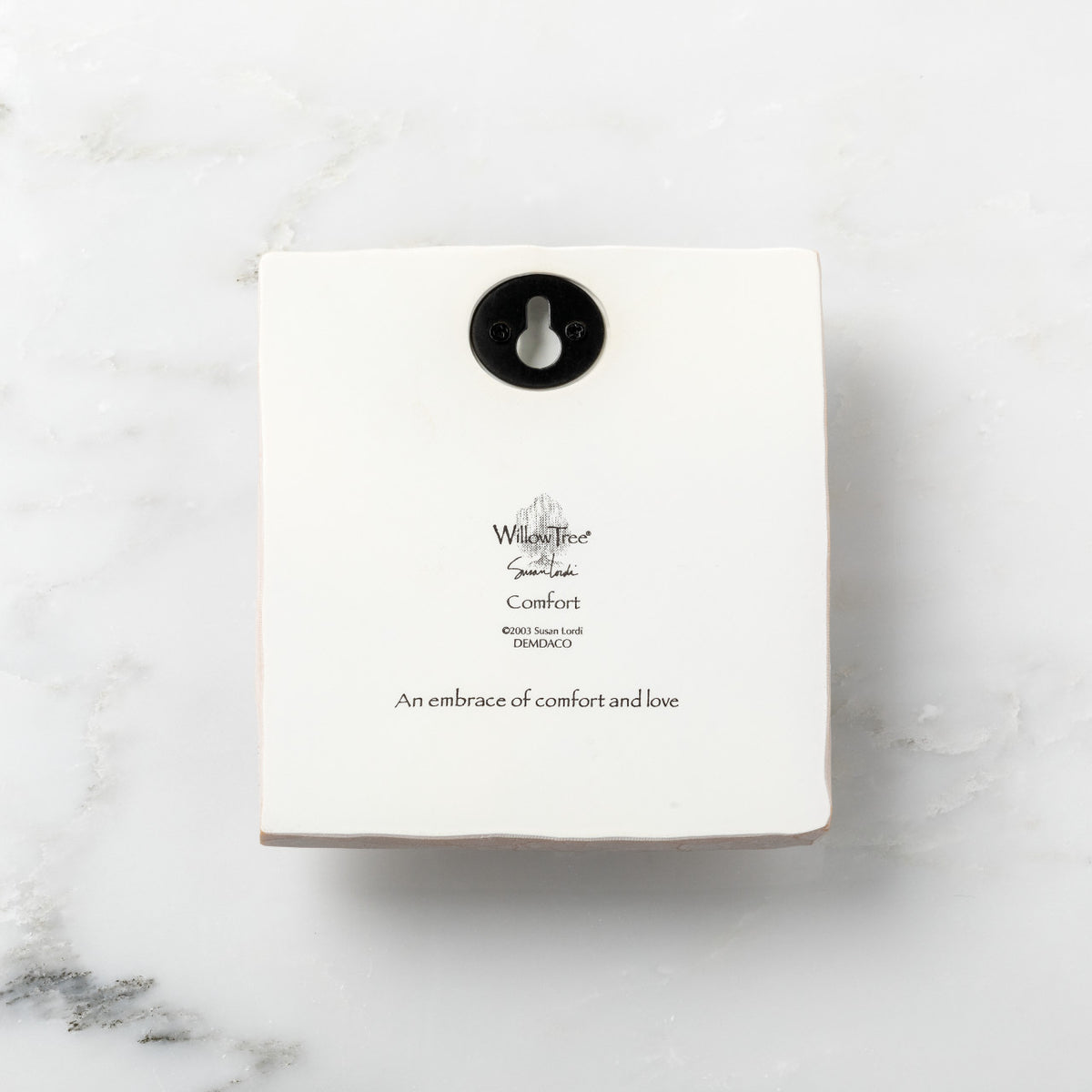 Back of white plaque reading piece title and sentiment, with Willow Tree logo