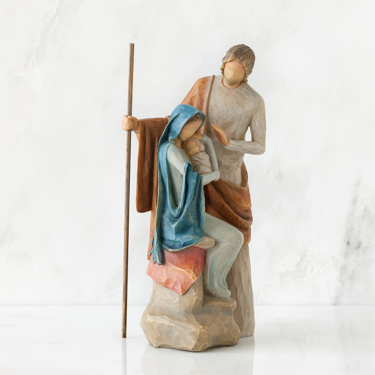 Nativity scene figurines sitting down holding baby