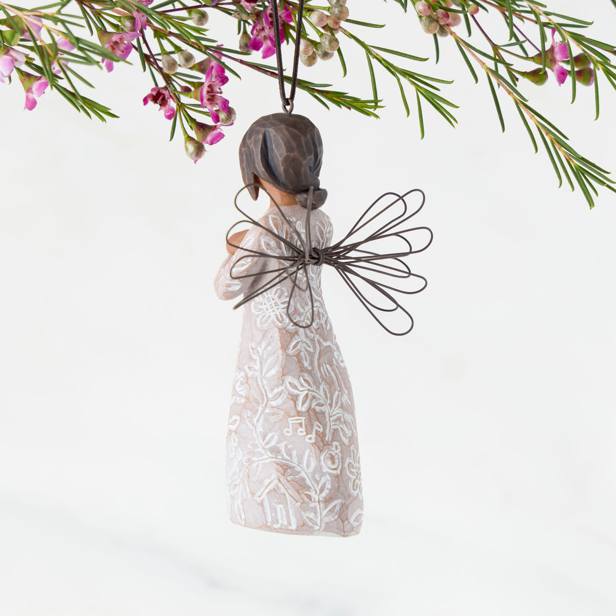 Back: Angel Ornament with wire wings, darker skin, dress carved with symbols of remembrance