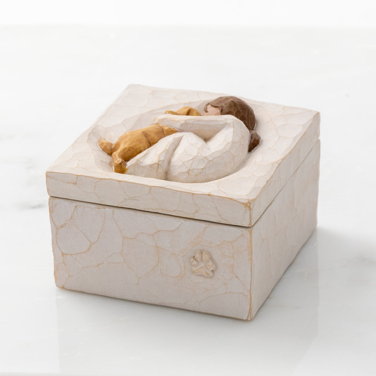 Willow Tree Friendship True Box, 3”sq x 2”h hand-painted resin box with removable lid. Lid has bas-relief carving of seated figure in cream dress, playing with yellow dog. Decorative paw icon carved onto box side