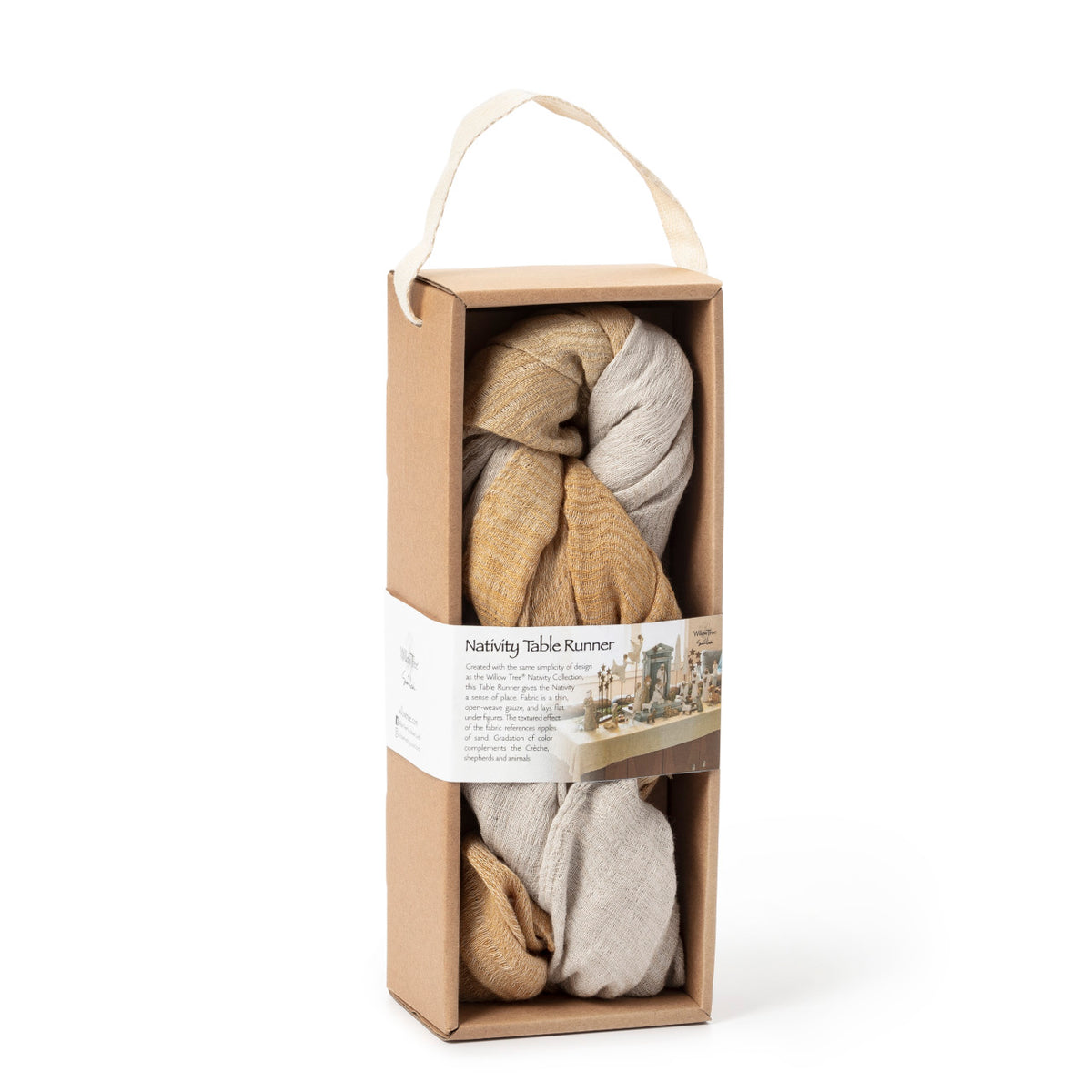 Cardboard package containing 2 ft by 5 ft gauze fabric with gradation of color along length of mustard to sand to mustard, to use under Nativity. Wraparound label features nativity display