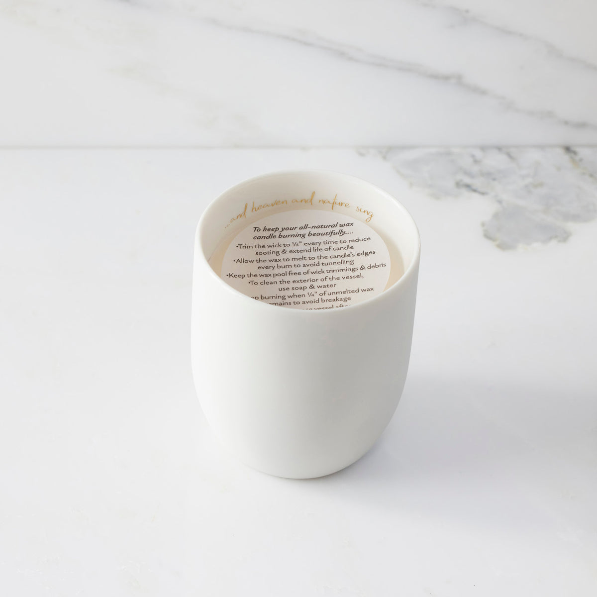 Top view of candle with vellum insert sheet with burning instructions