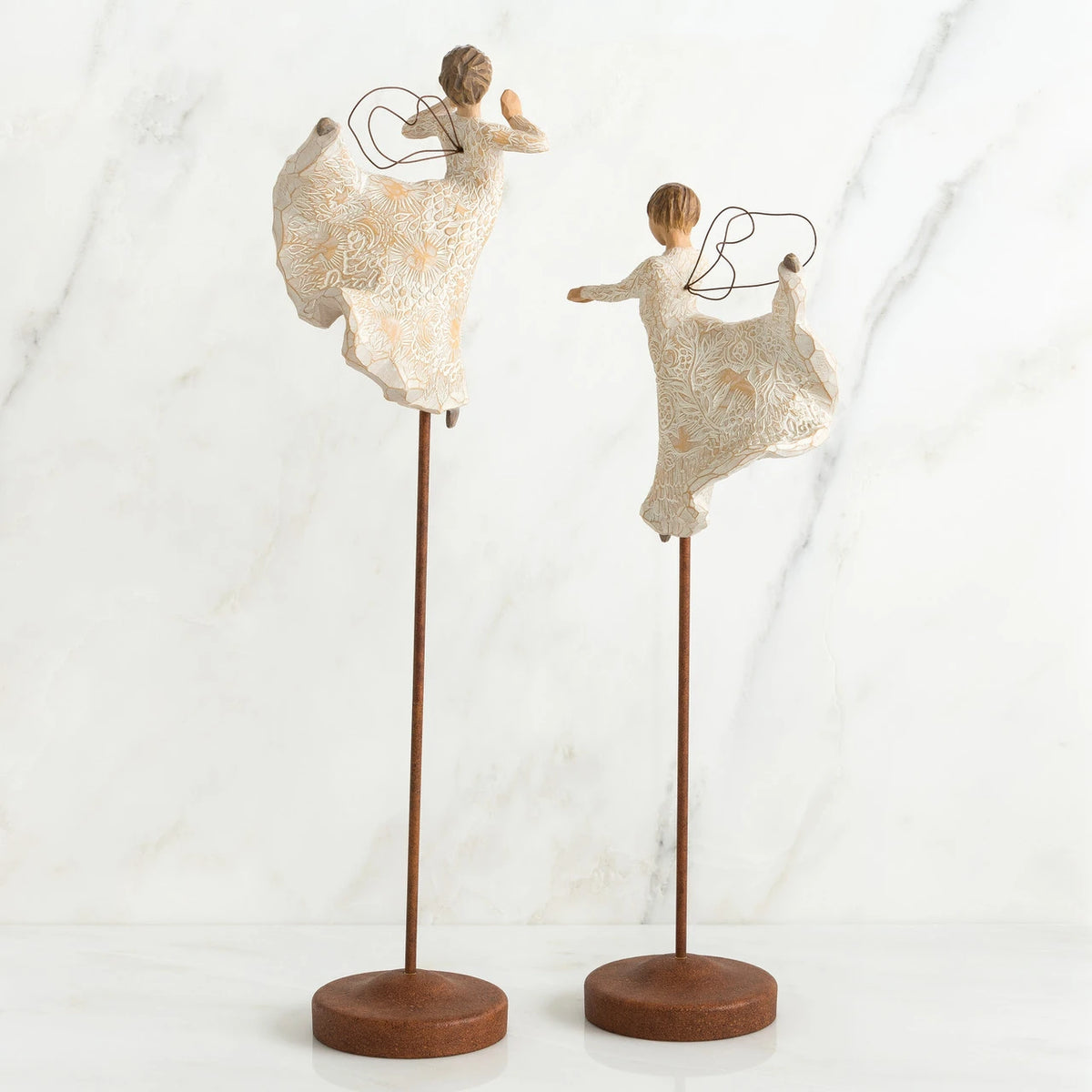 Set of two angel figurines in white dresses danging on wooden stands