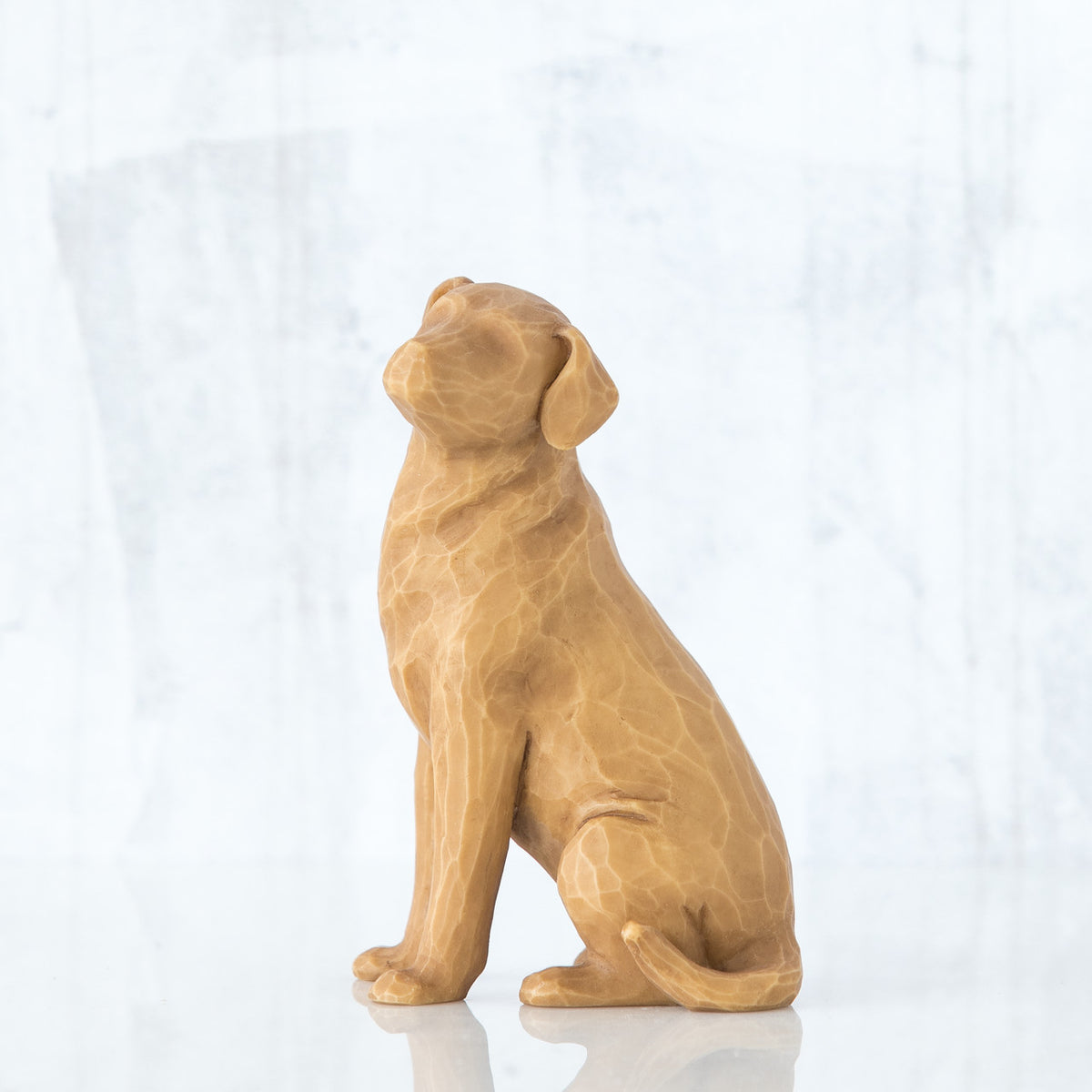 Light wooden dog figurine sitting up
