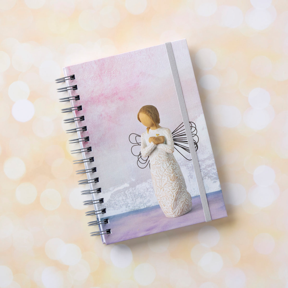 Willow Tree Remembrance Notebook, 6.5"w x 8.5"h, hard-cover, spiral-bound, 240 lined pages, front cover features Remembrance figure on background of purple-blue painting