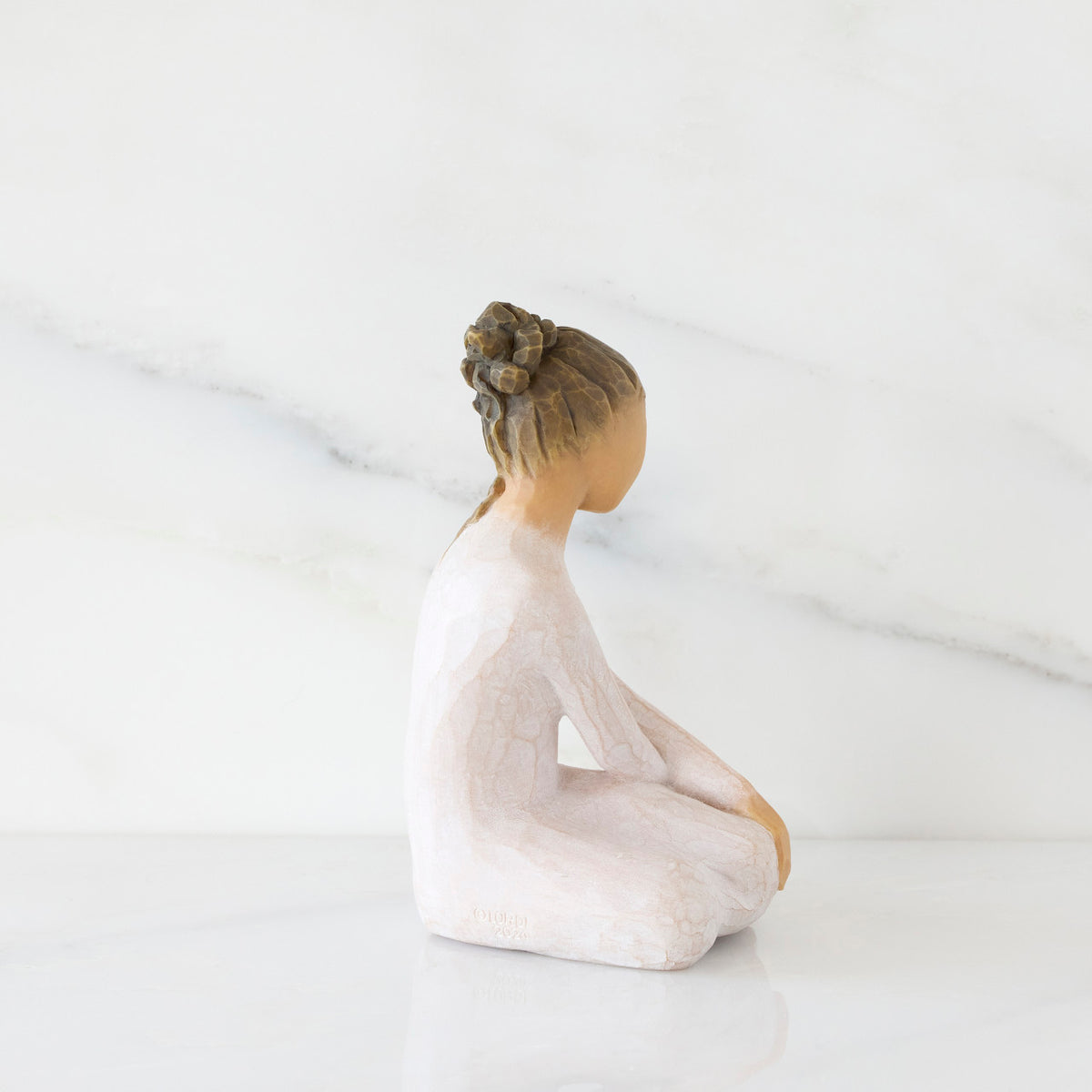 Right-facing view: seated figure in cream dress with crossed arms