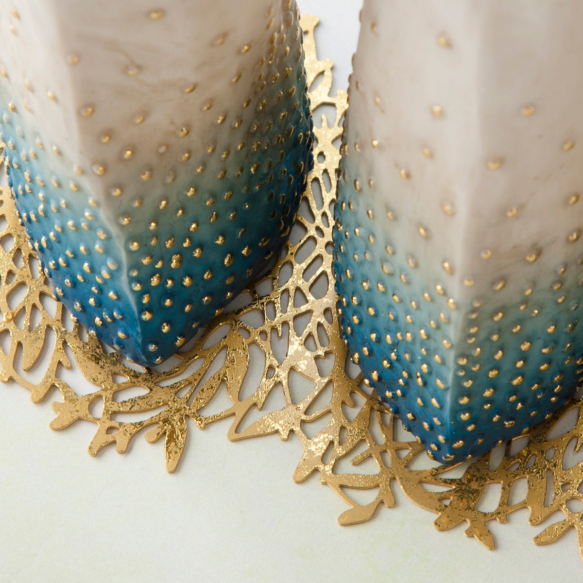 Close view of gold leaves print with blue/white statues on it