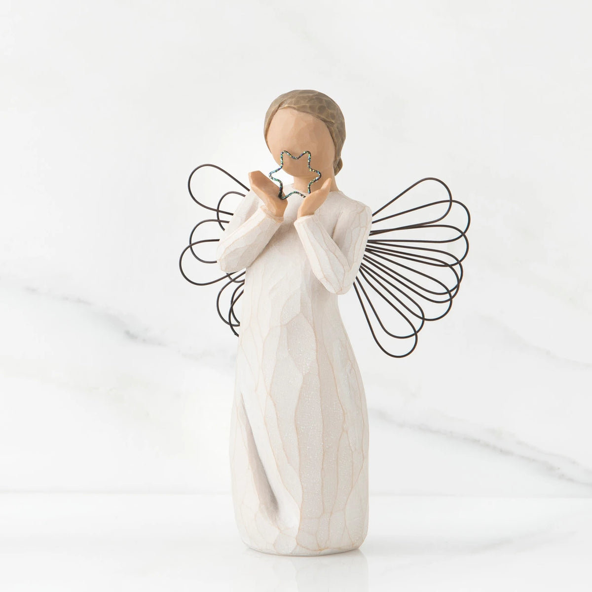 Small faceless angel girl wearing white dress, wire wings, and holding silver star