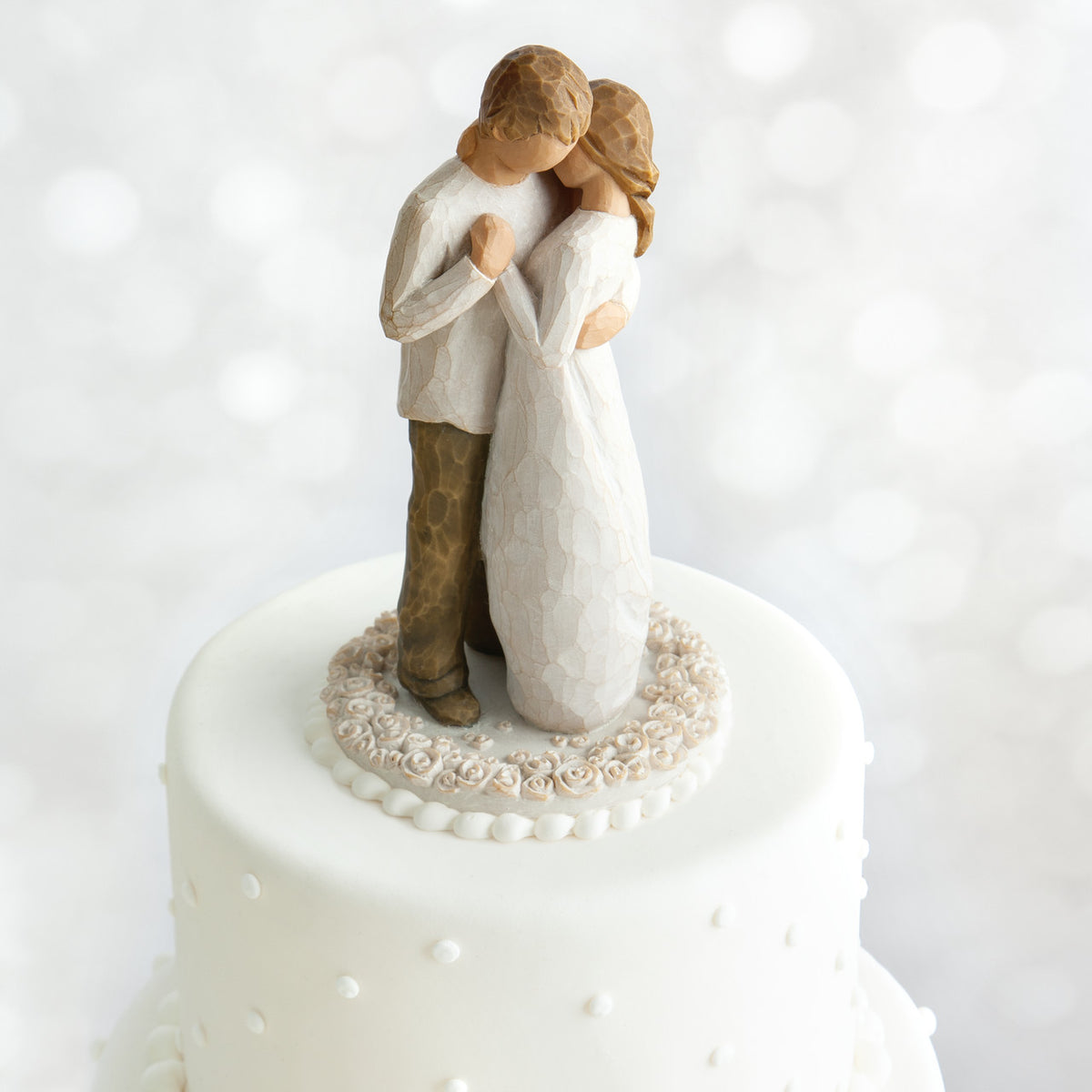 Willow Tree Promise Cake Topper, 6”h hand-painted resin figure of standing couple embracing or dancing, both in neutral colors, affixed to 3.5" diameter food-safe base carved with white roses