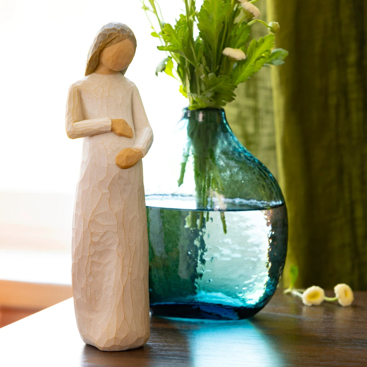 Willow Tree Cherish, 8.5”h hand-painted standing pregnant resin figure in cream dress, both hands on belly, on shelf with vase of flowers