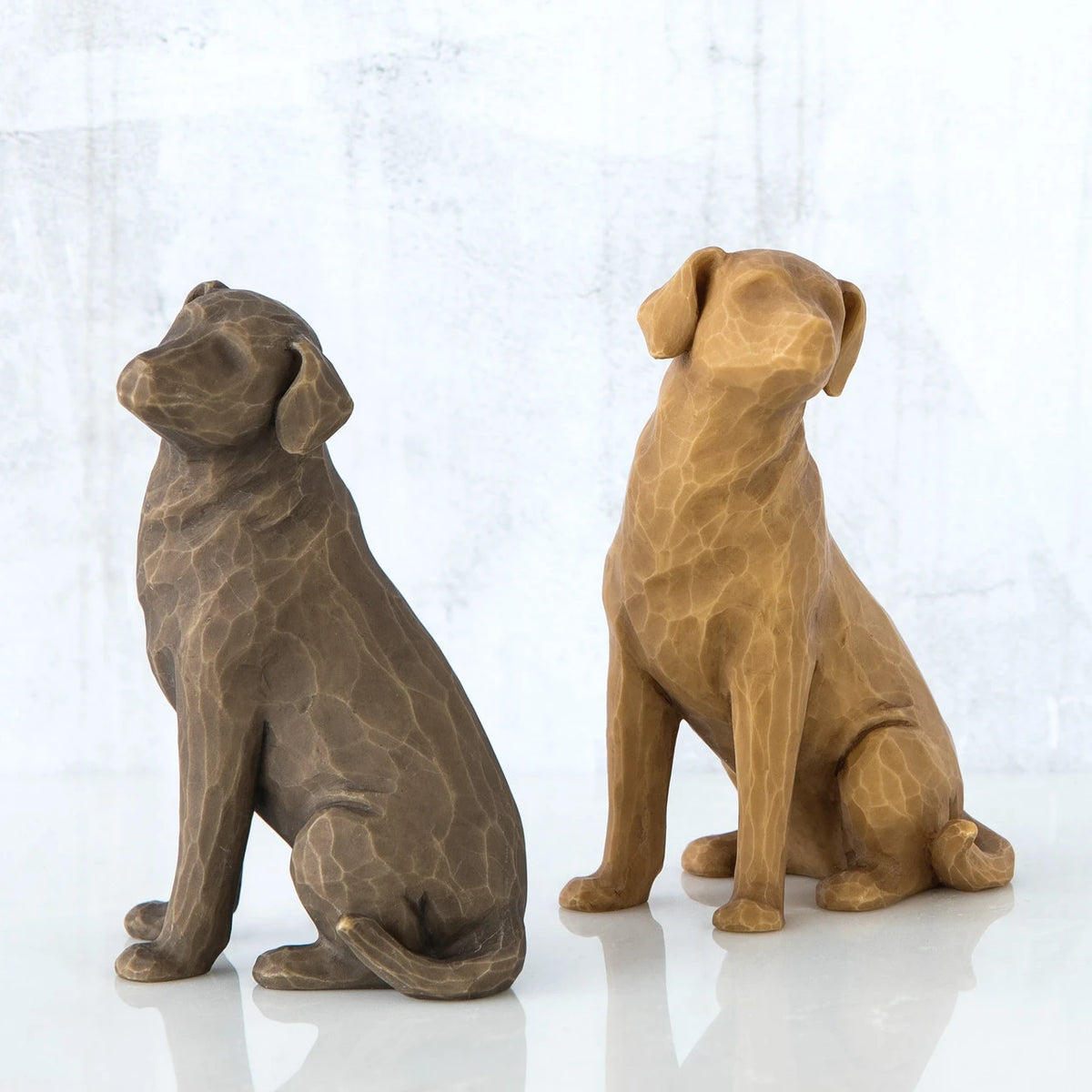 Light wooden dog figurine next to dark wooden dog figurine