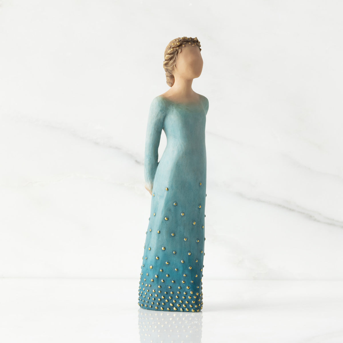 Facing front/right: Lighter-skin figure, arms clasped behind back, hair and deep blue ombré garment dotted with gold leaf