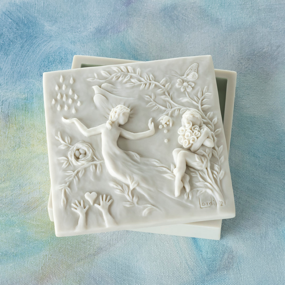 Willow Tree A Healing Wish Keepsake Box, 5"sq x 1.75"H hand-painted off-white resin box, detatched lid carved with organic/figural symbols, sentiment inside lid and velvety finish inside base, on blue painting