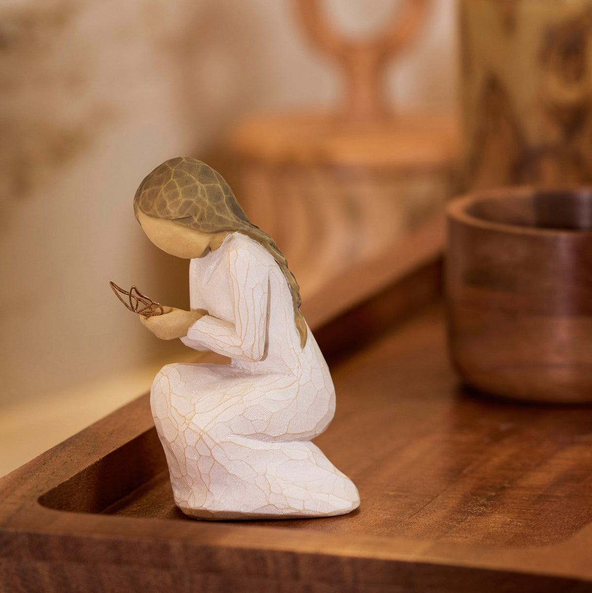 Willow Tree Quiet Wonder, 3.5”h hand-painted resin figure, kneeling in cream dress with gold leaf wire butterfly on extended hands, on dark wood tray