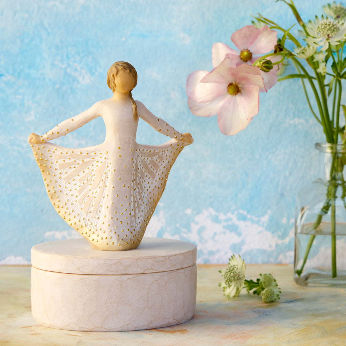 Willow Tree Butterfly Keepsake Box, 6.5"h x 4.5"h hand-painted oval resin box, 4.75”h figure holding cream skirt with carvings of monarch butterfly affixed to lid, open in front of sky blue painting