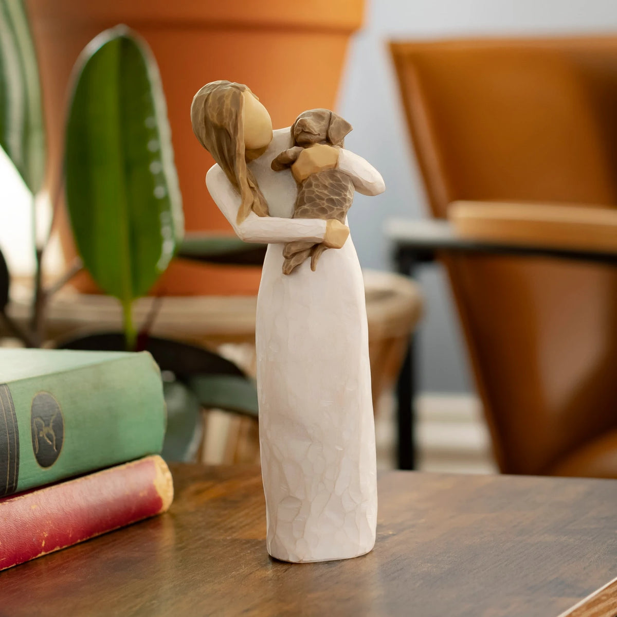 Willow Tree Adorable You (dark dog), 7.5”h hand-painted standing resin figure in cream dress, holding puppy, on wooden table